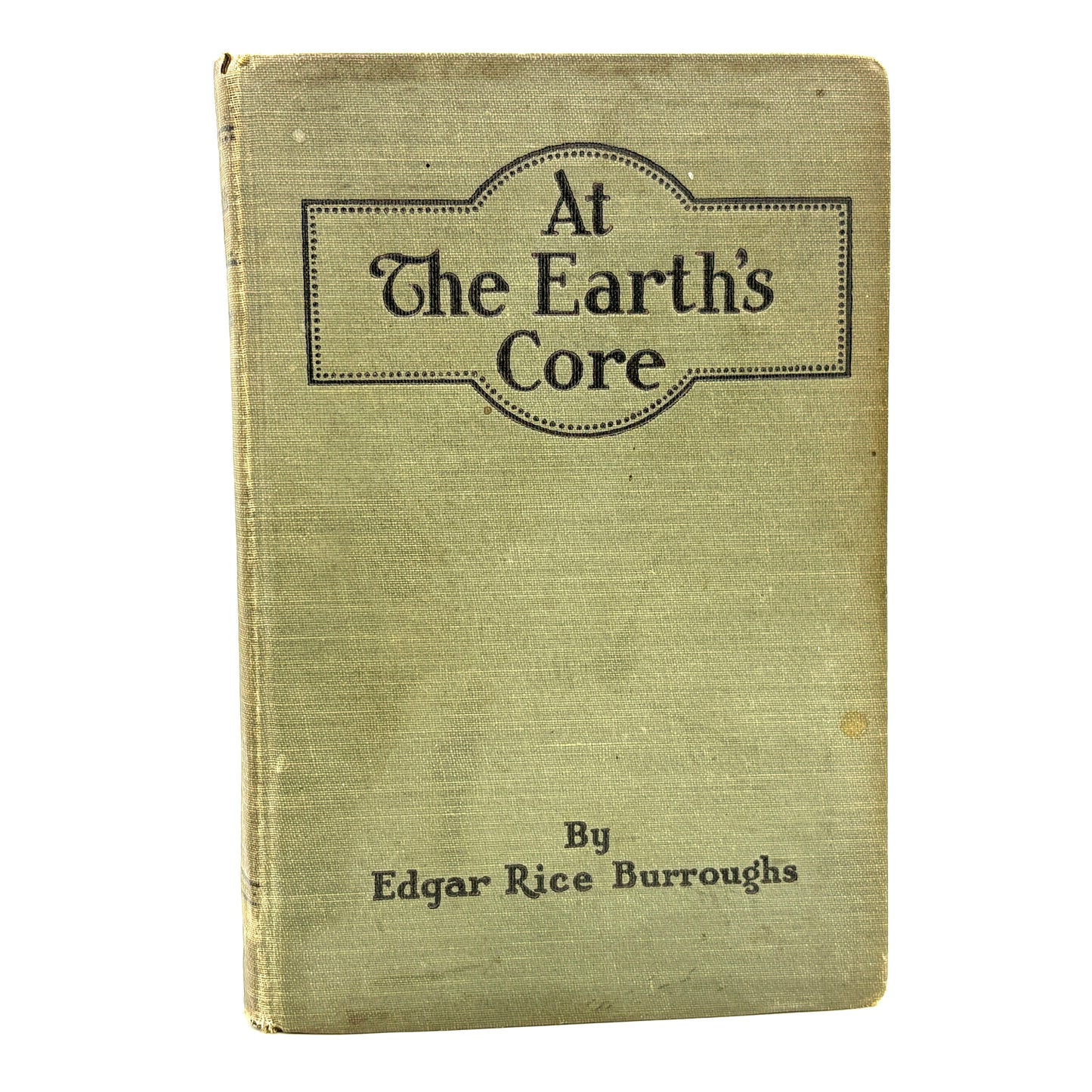 Book titled 'At The Earth's Core' by Edgar Rice Burroughs with a greenish cover.