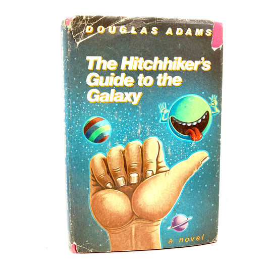 ADAMS, Douglas "The Hitchhiker's Guide to the Galaxy" [Harmony, 1979] - Buzz Bookstore