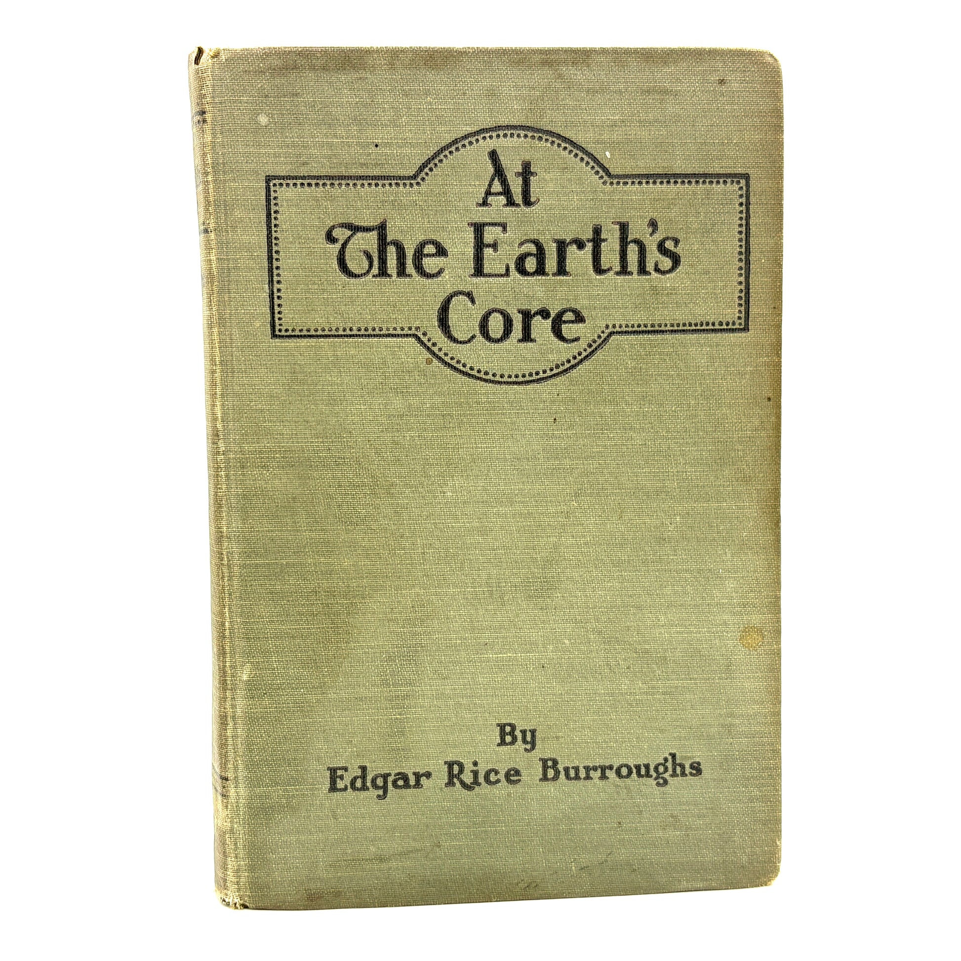 Book titled 'At The Earth's Core' by Edgar Rice Burroughs with a greenish cover.